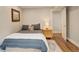 Cozy bedroom with a comfortable bed, stylish bedding, and wood flooring at 66 Yank Way, Lakewood, CO 80228
