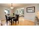 Cozy dining room features hardwood floors, a large window, and is open to living room at 66 Yank Way, Lakewood, CO 80228