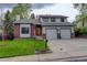 Charming two-story home with a well-manicured lawn and a two-car garage at 66 Yank Way, Lakewood, CO 80228
