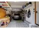 Garage featuring ample storage space, a workbench, and parking for a vehicle at 66 Yank Way, Lakewood, CO 80228