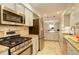 Bright kitchen features stainless steel appliances, granite countertops, and tile backsplash at 66 Yank Way, Lakewood, CO 80228