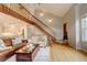 Bright and airy living room with an open floor plan and a wooden staircase at 66 Yank Way, Lakewood, CO 80228