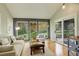 Bright living room with vaulted ceilings, a wall of windows and a sliding glass door to the backyard at 66 Yank Way, Lakewood, CO 80228