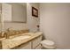 Stylish powder room featuring granite countertop, oval sink, and decorative accents at 66 Yank Way, Lakewood, CO 80228