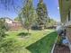 Lush backyard featuring tall trees and manicured garden beds at 5225 Beech St, Arvada, CO 80002
