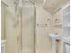 Clean bathroom with shower, vanity, and convenient storage shelves at 5225 Beech St, Arvada, CO 80002