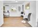 Bright breakfast nook area with hardwood floors, a white round table, and artwork at 5225 Beech St, Arvada, CO 80002