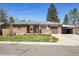Charming brick home with a well-maintained lawn, attached garage and a covered carport at 5225 Beech St, Arvada, CO 80002