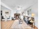 Inviting living room with a brick fireplace, bright windows, and hardwood floors at 5225 Beech St, Arvada, CO 80002