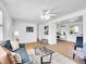 Open living room features hardwood floors and a glimpse of the breakfast nook at 5225 Beech St, Arvada, CO 80002