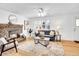 Bright living room boasts a brick fireplace, shuttered windows, and stylish decor at 5225 Beech St, Arvada, CO 80002