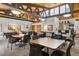 This clubhouse has exposed beam ceilings, tables, chairs, pool tables, and a bar area at 3470 S Poplar St # 102, Denver, CO 80224