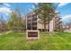Well-maintained Morningside Condominiums building with lush green lawn and mature trees on a sunny day at 3470 S Poplar St # 102, Denver, CO 80224