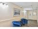 Cozy hallway with blue armchairs, neutral walls, modern lighting, and framed artwork adds a touch of elegance at 3470 S Poplar St # 102, Denver, CO 80224