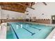 Indoor pool with swimming lanes, tiled walls, and large windows for natural light at 3470 S Poplar St # 102, Denver, CO 80224
