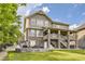 Two-story home with stone and siding, plus a spacious backyard and lower level seating area at 7892 S Country Club Pkwy, Aurora, CO 80016