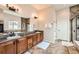 Spacious bathroom with dual vanity, granite counters, and tiled floors at 7892 S Country Club Pkwy, Aurora, CO 80016