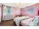 Bright bedroom features a chandelier, a desk, and a large window for ample natural light at 7892 S Country Club Pkwy, Aurora, CO 80016