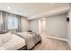 Neutral-toned bedroom with soft carpet, a window with blinds and curtains, and ample space at 7892 S Country Club Pkwy, Aurora, CO 80016