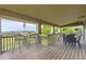 Large covered patio with beautiful neighborhood views, bar seating, and space for entertaining at 7892 S Country Club Pkwy, Aurora, CO 80016