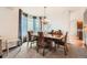 Dining room with modern chandelier, large windows, and formal dining set at 7892 S Country Club Pkwy, Aurora, CO 80016