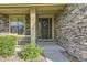Stone clad home exterior featuring an elegant front door with decorative wreath at 7892 S Country Club Pkwy, Aurora, CO 80016