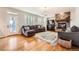 Bright living room with stone fireplace, hardwood floors, and comfortable seating at 7892 S Country Club Pkwy, Aurora, CO 80016