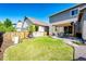Backyard boasts a pergola covered patio, green grass, landscaping and privacy fence at 3966 Long Rifle Dr, Castle Rock, CO 80108
