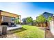Backyard with patio, pergola, green grass, landscaping, and privacy fence at 3966 Long Rifle Dr, Castle Rock, CO 80108
