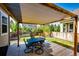Backyard patio with wooden pergola, table, and chairs overlooking the fenced yard at 3966 Long Rifle Dr, Castle Rock, CO 80108