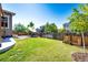 Grassy backyard features a seating area, landscaping, and privacy fence at 3966 Long Rifle Dr, Castle Rock, CO 80108