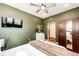 Bedroom with green walls, closet, a TV and a white bed at 3966 Long Rifle Dr, Castle Rock, CO 80108