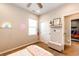 Comfortable bedroom with a neon sign, ceiling fan, and natural light from the window at 3966 Long Rifle Dr, Castle Rock, CO 80108
