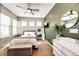 Bedroom features natural light, plush carpet, and a dresser with a round mirror at 3966 Long Rifle Dr, Castle Rock, CO 80108