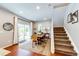 Bright dining area with hardwood floors, sliding glass doors, and staircase access at 3966 Long Rifle Dr, Castle Rock, CO 80108