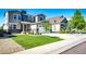 Attractive two-story home with a green lawn, stone details, and a two-car garage in a neighborhood setting at 3966 Long Rifle Dr, Castle Rock, CO 80108