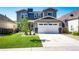 Beautiful two-story home with a well-kept lawn and an attached two-car garage on a sunny day at 3966 Long Rifle Dr, Castle Rock, CO 80108
