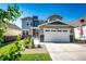 Charming two-story home with a well-manicured lawn, stone accents, and an attached two-car garage at 3966 Long Rifle Dr, Castle Rock, CO 80108