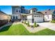 Lovely two-story home with a manicured lawn, stone accents, and an attached two-car garage under a clear sky at 3966 Long Rifle Dr, Castle Rock, CO 80108