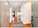Inviting entryway with a barn door, hardwood floors, and views into the living and dining areas at 3966 Long Rifle Dr, Castle Rock, CO 80108