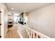 Bright hallway showcasing an open living room and bedroom, complemented by a white staircase railing at 3966 Long Rifle Dr, Castle Rock, CO 80108