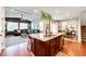 Open-concept kitchen featuring a granite island, stainless steel appliances, and hardwood floors at 3966 Long Rifle Dr, Castle Rock, CO 80108