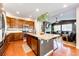 Open kitchen with stainless steel appliances, granite counters, a center island, and hardwood flooring flowing into the living area at 3966 Long Rifle Dr, Castle Rock, CO 80108