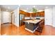 Modern kitchen with stainless steel appliances, granite countertops, an island with seating, and hardwood floors at 3966 Long Rifle Dr, Castle Rock, CO 80108
