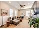 Well-lit living room with a sectional sofa, stylish decor, and a ceiling fan at 3966 Long Rifle Dr, Castle Rock, CO 80108