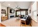 Cozy living room with a fireplace, TV, ceiling fan and comfortable seating area at 3966 Long Rifle Dr, Castle Rock, CO 80108