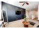 Living room featuring a modern accent wall, ceiling fan and comfortable sectional sofa at 3966 Long Rifle Dr, Castle Rock, CO 80108