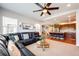 Open concept living room flowing into a kitchen with counter seating and hardwood floors at 3966 Long Rifle Dr, Castle Rock, CO 80108