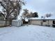 Snowy backyard with shed and partial home view at 17422 E Progress Dr, Centennial, CO 80015