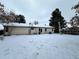 Snowy backyard with home and patio visible at 17422 E Progress Dr, Centennial, CO 80015